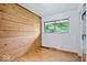 Bedroom with wood-paneled accent wall and hardwood floors at 9996 N County Road 200 W, Muncie, IN 47302