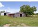 Rustic wood barn with open bay doors and adjacent trees at 9996 N County Road 200 W, Muncie, IN 47302