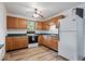 Bright kitchen featuring wood cabinets and white appliances at 9996 N County Road 200 W, Muncie, IN 47302