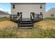 Newly stained deck with steps leading to the backyard at 3154 Mcintosh Dr, Bargersville, IN 46106