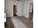 View of a kitchen with light grey vinyl flooring, white cabinets and a center island at 3526 N Capitol Ave, Indianapolis, IN 46208
