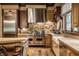 Updated kitchen featuring a farmhouse sink, wood floors, and custom cabinetry at 841 Alverna Dr, Indianapolis, IN 46260