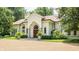 Grand entrance with a charming wooden door, lush landscaping, and a gravel driveway at 841 Alverna Dr, Indianapolis, IN 46260
