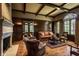 Cozy library with built-in bookshelves, fireplace, and leather armchairs at 841 Alverna Dr, Indianapolis, IN 46260