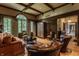Elegant living room with leather furniture, hardwood floors, and large windows at 841 Alverna Dr, Indianapolis, IN 46260