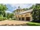 Three-car garage with arched entryway and a Mediterranean style home at 841 Alverna Dr, Indianapolis, IN 46260