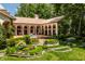 Landscaped backyard with tiered gardens, fountain, and expansive lawn at 841 Alverna Dr, Indianapolis, IN 46260