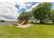 Play area with a wooden playset, picnic table, and basketball court nearby at 3917 N 525 W, Fairland, IN 46126