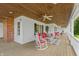 Spacious front porch with seating and ceiling fan, overlooking a yard at 3917 N 525 W, Fairland, IN 46126