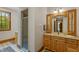 Bathroom with shower, vanity with drawers, and a decorative mirror at 3917 N 525 W, Fairland, IN 46126