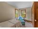 Bright bedroom with a twin bed and sitting area at 3917 N 525 W, Fairland, IN 46126