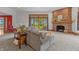 Living room with brick fireplace, access to backyard, and comfortable seating at 3917 N 525 W, Fairland, IN 46126