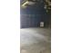 Empty garage with concrete floor and overhead door at 41 S Sherman Dr, Indianapolis, IN 46201