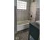 Updated bathroom with a bathtub, marble tile, and gray vanity at 41 S Sherman Dr, Indianapolis, IN 46201
