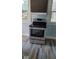 Stainless steel range with modern controls in a renovated kitchen at 41 S Sherman Dr, Indianapolis, IN 46201
