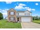 Two-story brick home with a two-car garage and landscaped yard at 1560 Cold Spring Dr, Brownsburg, IN 46112