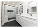Modern bathroom with white subway tile, double vanity, and hexagon floor at 706 S Main St, Whitestown, IN 46075