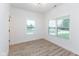 Well-lit bedroom featuring wood-look flooring and two windows at 706 S Main St, Whitestown, IN 46075