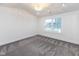Bright bedroom with grey carpet, chandelier, and large window at 706 S Main St, Whitestown, IN 46075