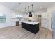 Modern kitchen with white cabinets, quartz countertops, and stainless steel appliances at 706 S Main St, Whitestown, IN 46075