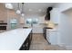 Modern kitchen with white cabinets, black island, and quartz countertops at 706 S Main St, Whitestown, IN 46075