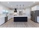 Modern kitchen with white cabinets, quartz countertops, and stainless steel appliances at 706 S Main St, Whitestown, IN 46075
