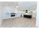 Open floor plan with kitchen island, fireplace, and hardwood floors at 706 S Main St, Whitestown, IN 46075