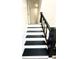 View of a staircase with dark wood railing and white risers at 3442 N Capitol Ave, Indianapolis, IN 46208