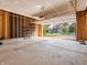 Unfinished garage with open door and storage shelving at 7054 Lavender Ct, Indianapolis, IN 46237