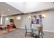 Modern dining area with a glass table and chairs, situated near an open living space at 610 N Park Ave, Indianapolis, IN 46204