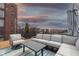 Rooftop deck boasts stunning sunset views, sectional sofa, and outdoor dining area at 610 N Park Ave, Indianapolis, IN 46204