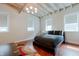 Bright bedroom with hardwood floors, exposed beams, and large windows at 610 N Park Ave, Indianapolis, IN 46204
