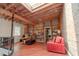 Spacious home office with exposed beams, built-in shelves, and brick wall at 610 N Park Ave, Indianapolis, IN 46204