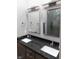 Modern bathroom with double vanity, granite countertop, and glass shower at 610 N Park Ave, Indianapolis, IN 46204