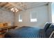 Bedroom with exposed brick wall, hardwood floors, and window at 610 N Park Ave, Indianapolis, IN 46204