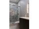 Updated bathroom features a walk-in shower, dark vanity, and a modern lighting fixture at 610 N Park Ave, Indianapolis, IN 46204