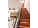 Elegant wooden staircase with cable railing and brick wall at 610 N Park Ave, Indianapolis, IN 46204