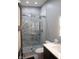 Modern bathroom with a frameless glass shower, marble-look tile, and sleek vanity at 610 N Park Ave, Indianapolis, IN 46204