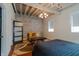 Spacious bedroom with exposed brick wall, hardwood floors, and window at 610 N Park Ave, Indianapolis, IN 46204