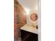 Stylish bathroom with exposed brick and terrazzo countertop at 610 N Park Ave, Indianapolis, IN 46204