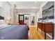 Spacious bedroom with hardwood floors and a red accent chair at 805 Iowa St, Indianapolis, IN 46203
