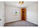 Bright bedroom with grey carpet, built-in shelving, and a window with natural light at 805 Iowa St, Indianapolis, IN 46203