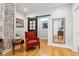 Open living area with exposed brick and a stylish red armchair at 805 Iowa St, Indianapolis, IN 46203