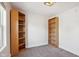 Spacious bedroom with grey carpet and two sets of built-in shelves at 805 Iowa St, Indianapolis, IN 46203