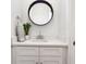 Modern bathroom with white vanity, round mirror, and quartz countertop at 805 Iowa St, Indianapolis, IN 46203