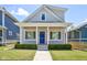 Charming gray house with a blue door, white columns, and well-manicured lawn at 805 Iowa St, Indianapolis, IN 46203