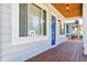 Covered porch with a blue door, wood floor, and a view of the neighborhood at 805 Iowa St, Indianapolis, IN 46203