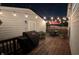 Evening view of a backyard deck with string lights, grill and patio furniture at 805 Iowa St, Indianapolis, IN 46203