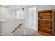 Upstairs hallway with bookshelf and bathroom access at 805 Iowa St, Indianapolis, IN 46203