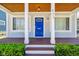 Inviting front porch with a blue door and a wood-grain floor at 805 Iowa St, Indianapolis, IN 46203